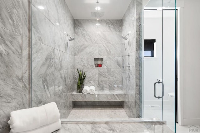 full bathroom with a shower stall and visible vents