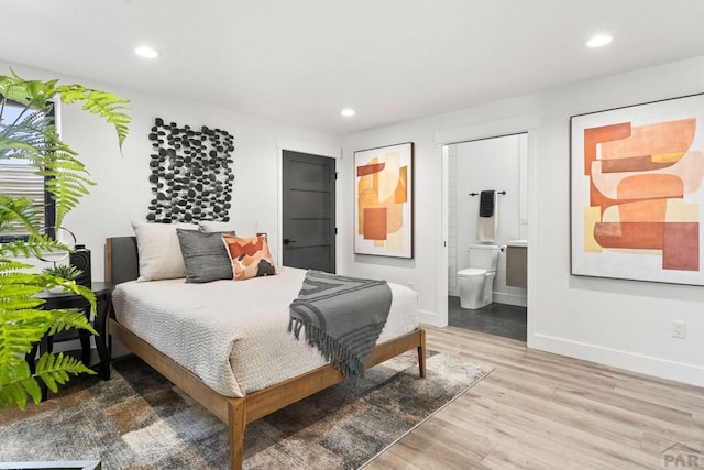 bedroom featuring recessed lighting, light wood-type flooring, ensuite bathroom, and baseboards