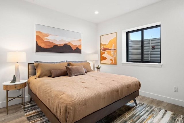 bedroom featuring recessed lighting, wood finished floors, and baseboards