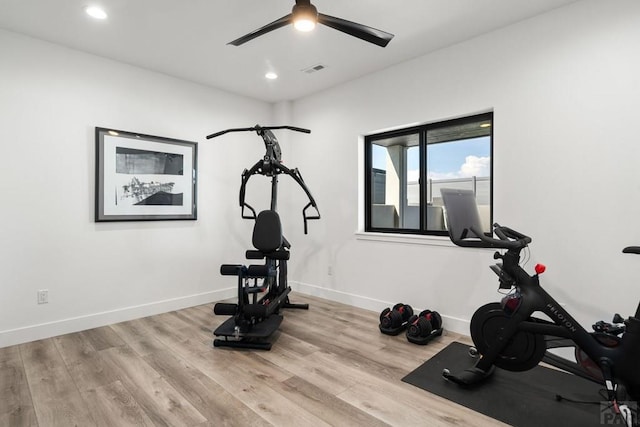 exercise room with visible vents, baseboards, and wood finished floors