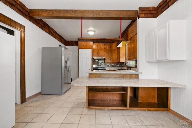 2325 W St, Pueblo, CO 81003 - kitchen featuring stainless steel refrigerator with ice dispenser, a peninsula, beam ceiling, light countertops, and light tile patterned flooring