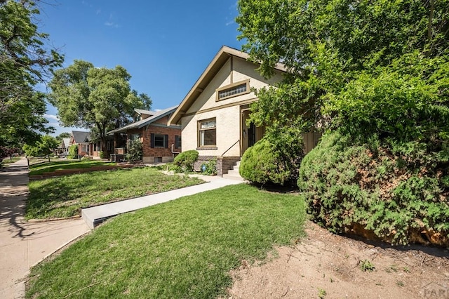 2325 W St, Pueblo, CO 81003 - view of front of house with brick siding and a front lawn
