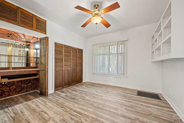 2325 W St, Pueblo, CO 81003 - unfurnished bedroom featuring wood finished floors, a closet, and a ceiling fan
