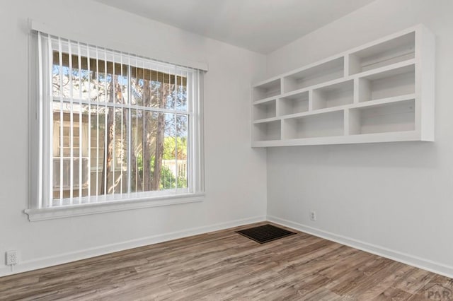 2325 W St, Pueblo, CO 81003 - empty room featuring wood finished floors and plenty of natural light