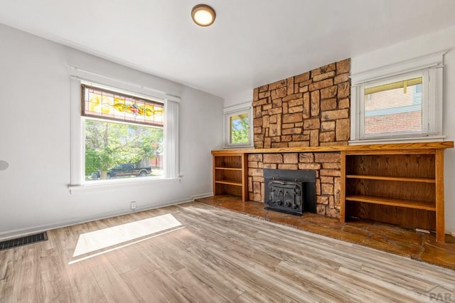2325 W St, Pueblo, CO 81003 - unfurnished living room with wood finished floors and a wood stove