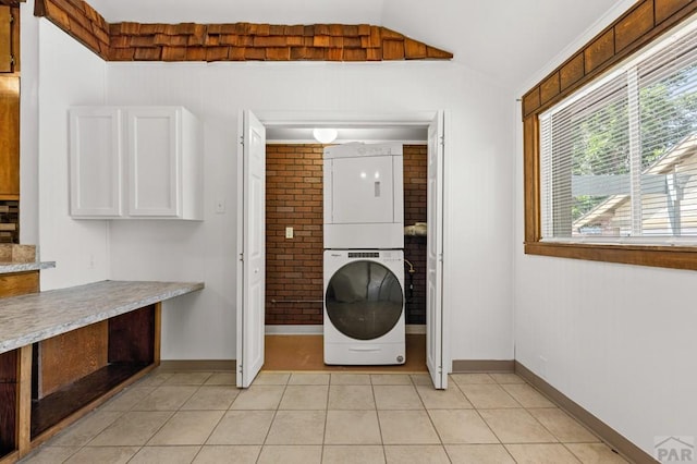 2325 W St, Pueblo, CO 81003 - washroom featuring stacked washing machine and dryer and light tile patterned floors