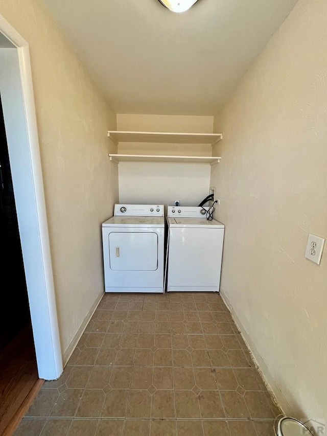 laundry area with washer and clothes dryer, laundry area, and baseboards