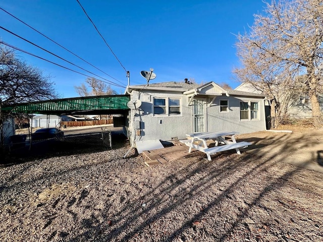 back of house with stucco siding