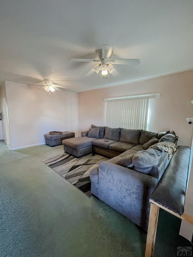 living room featuring carpet, a ceiling fan, and baseboards