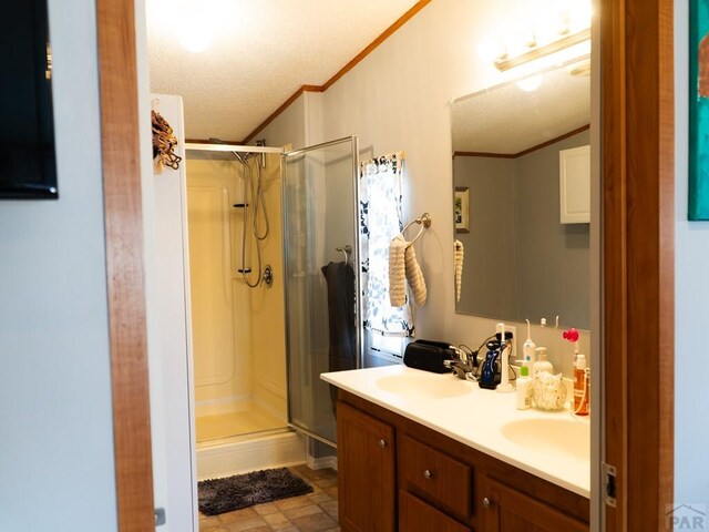 full bath with ornamental molding, a sink, and a shower stall