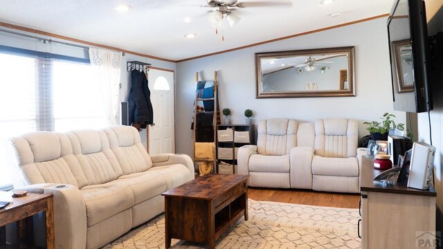 living area featuring a ceiling fan, recessed lighting, crown molding, and light wood-style flooring