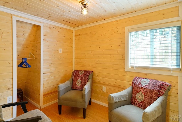 living area with wood walls, wood finished floors, and wood ceiling