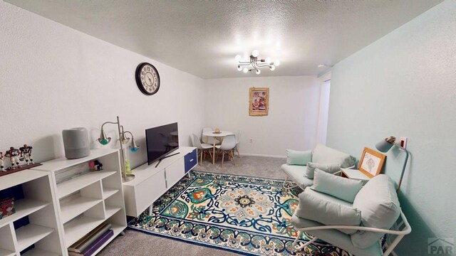 356 S Littler Dr, Pueblo West, CO 81007 - carpeted living area with a chandelier and a textured ceiling