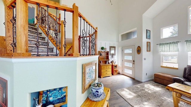 356 S Littler Dr, Pueblo West, CO 81007 - entryway featuring a towering ceiling, wood finished floors, stairs, and baseboards