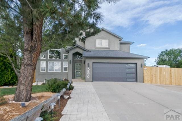 356 S Littler Dr, Pueblo West, CO 81007 - view of front of property featuring an attached garage, concrete driveway, and stucco siding