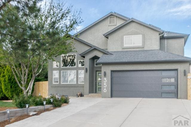 356 S Littler Dr, Pueblo West, CO 81007 - view of front facade with stucco siding, concrete driveway, and a garage