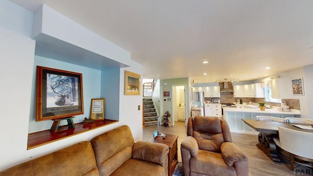 356 S Littler Dr, Pueblo West, CO 81007 - living room with light wood-style flooring, stairway, and recessed lighting