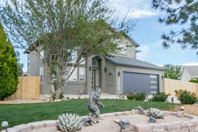 356 S Littler Dr, Pueblo West, CO 81007 - view of front of house with stucco siding and a garage