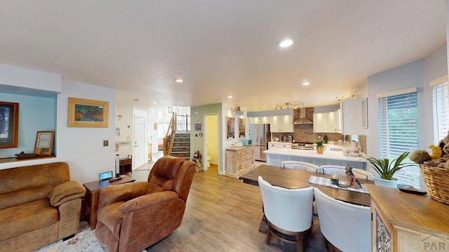 356 S Littler Dr, Pueblo West, CO 81007 - living area featuring stairs, light wood-style floors, and recessed lighting