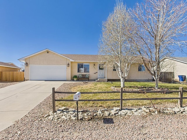 single story home featuring a fenced front yard, stucco siding, an attached garage, and concrete driveway