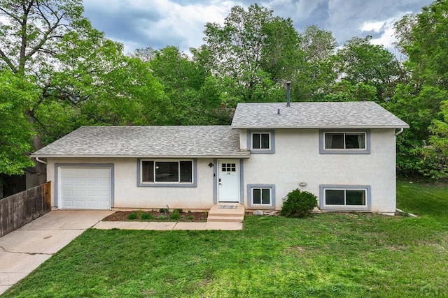 20 N 32nd St, Colorado Springs, CO 80904 - tri-level home with a garage, stucco siding, roof with shingles, and driveway