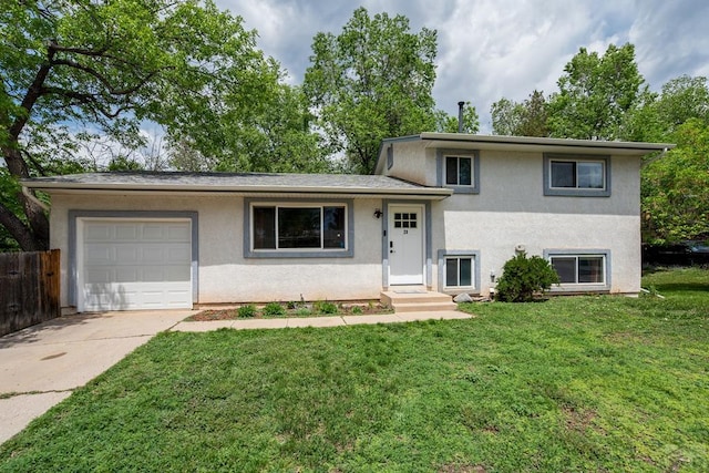 20 N 32nd St, Colorado Springs, CO 80904 - split level home featuring an attached garage, stucco siding, and concrete driveway