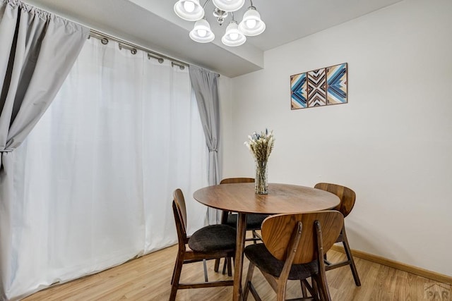 20 N 32nd St, Colorado Springs, CO 80904 - dining room with a chandelier, light wood-style flooring, and baseboards
