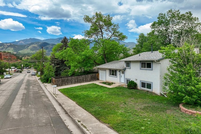 20 N 32nd St, Colorado Springs, CO 80904 - view of front of house featuring a mountain view, stucco siding, a garage, and driveway