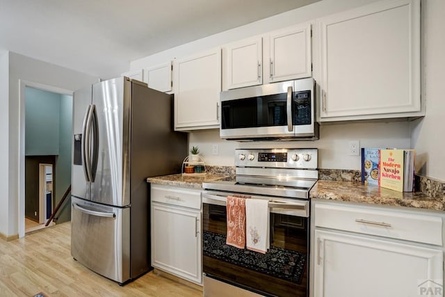 20 N 32nd St, Colorado Springs, CO 80904 - kitchen featuring stainless steel appliances, light wood-style flooring, white cabinets, and light stone countertops