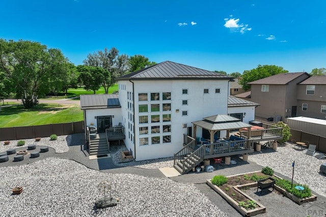 489 S Pin High Dr, Pueblo West, CO 81007 - back of house with a gazebo, a wooden deck, a standing seam roof, metal roof, and stucco siding