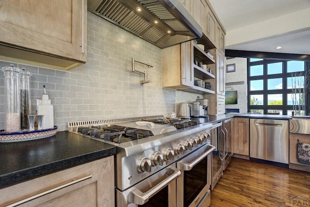 489 S Pin High Dr, Pueblo West, CO 81007 - kitchen with appliances with stainless steel finishes, premium range hood, dark countertops, tasteful backsplash, and dark wood-type flooring