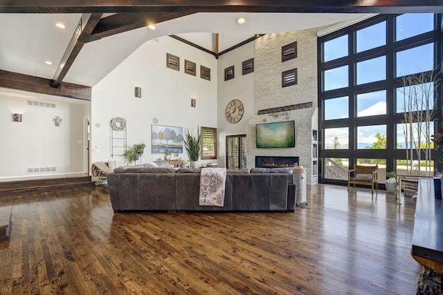 489 S Pin High Dr, Pueblo West, CO 81007 - living area with high vaulted ceiling, beamed ceiling, dark wood-style floors, a fireplace, and baseboards