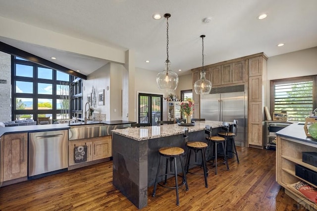 489 S Pin High Dr, Pueblo West, CO 81007 - kitchen featuring stainless steel appliances, a sink, dark wood-style floors, a center island, and recessed lighting