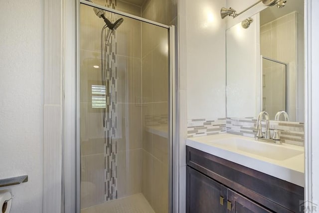 489 S Pin High Dr, Pueblo West, CO 81007 - bathroom featuring a shower stall, vanity, and tasteful backsplash