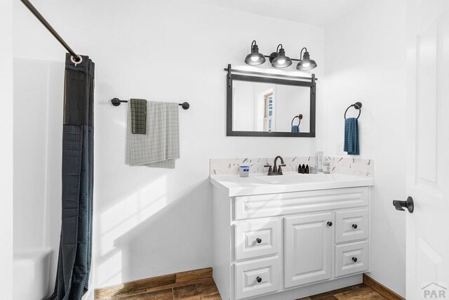 31 Bess St, Westcliffe, CO 81252 - bathroom with wood finished floors, vanity, and a shower with curtain
