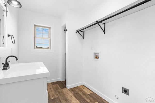 31 Bess St, Westcliffe, CO 81252 - clothes washing area featuring a barn door, hookup for an electric dryer, laundry area, dark wood-type flooring, and a sink