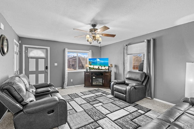 living room featuring light carpet, a ceiling fan, and a wealth of natural light