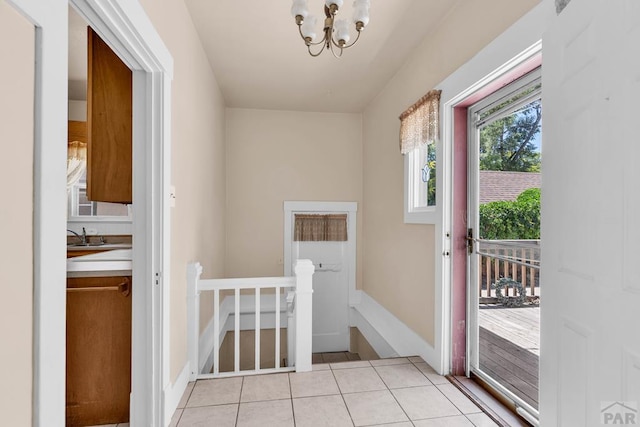 2121 N Greenwood St, Pueblo, CO 81003 - doorway to outside featuring light tile patterned flooring and a chandelier