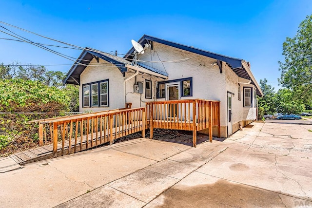 2121 N Greenwood St, Pueblo, CO 81003 - rear view of house featuring stucco siding and a wooden deck