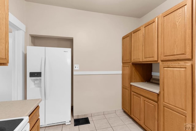 2121 N Greenwood St, Pueblo, CO 81003 - kitchen with white refrigerator with ice dispenser, light countertops, and light tile patterned floors