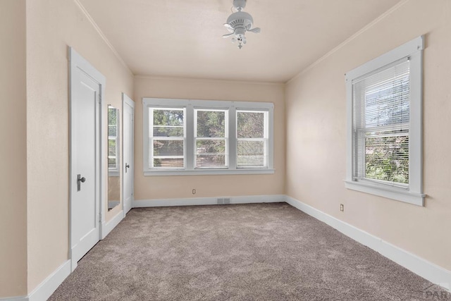 2121 N Greenwood St, Pueblo, CO 81003 - spare room featuring healthy amount of natural light, carpet, and crown molding