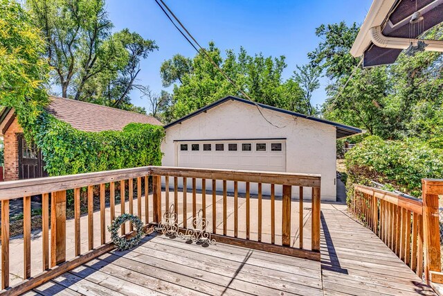 2121 N Greenwood St, Pueblo, CO 81003 - wooden terrace featuring a detached garage and an outdoor structure