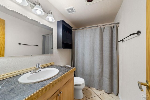 full bathroom with visible vents, vanity, toilet, and tile patterned floors