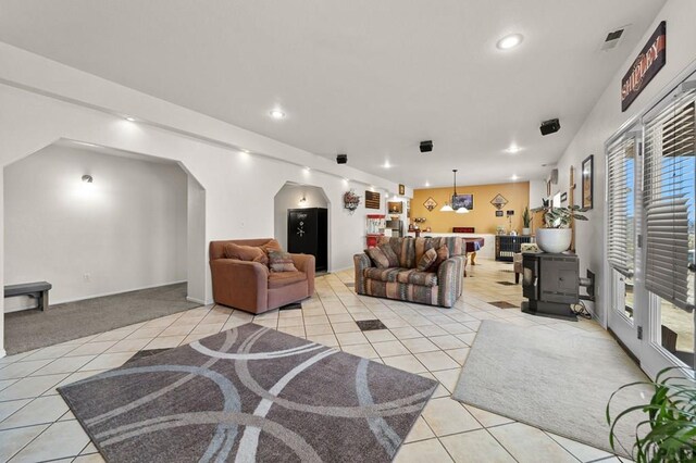 living area featuring recessed lighting, light carpet, visible vents, and light tile patterned floors