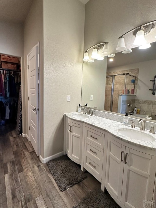 822 S Espanola Dr, Pueblo West, CO 81007 - full bathroom featuring a shower stall, a sink, and wood finished floors
