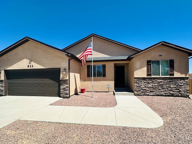 822 S Espanola Dr, Pueblo West, CO 81007 - ranch-style home with a garage, driveway, stone siding, and stucco siding