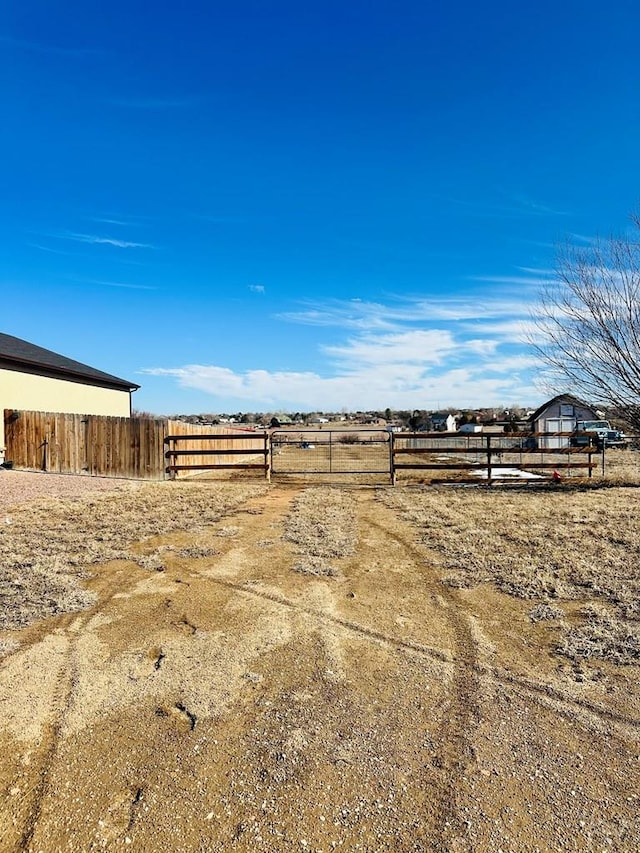 view of yard with a rural view and fence