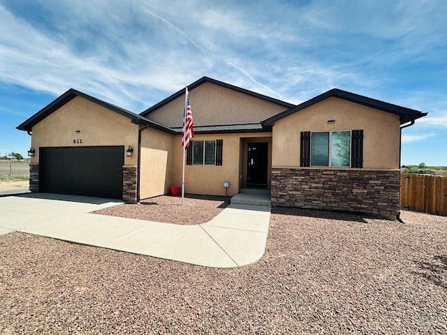 822 S Espanola Dr, Pueblo West, CO 81007 - ranch-style home featuring an attached garage, stucco siding, stone siding, and fence