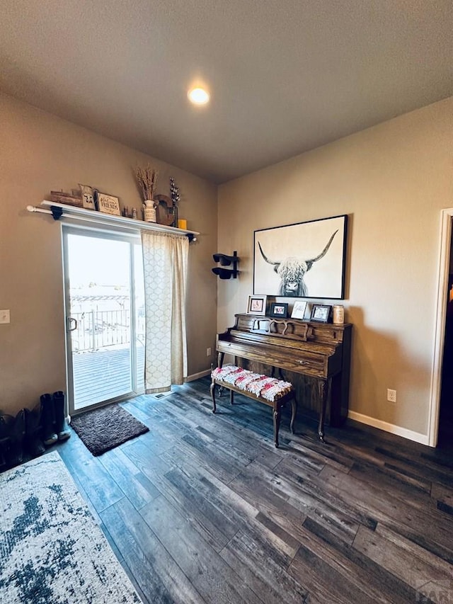 foyer featuring dark wood-style floors and baseboards