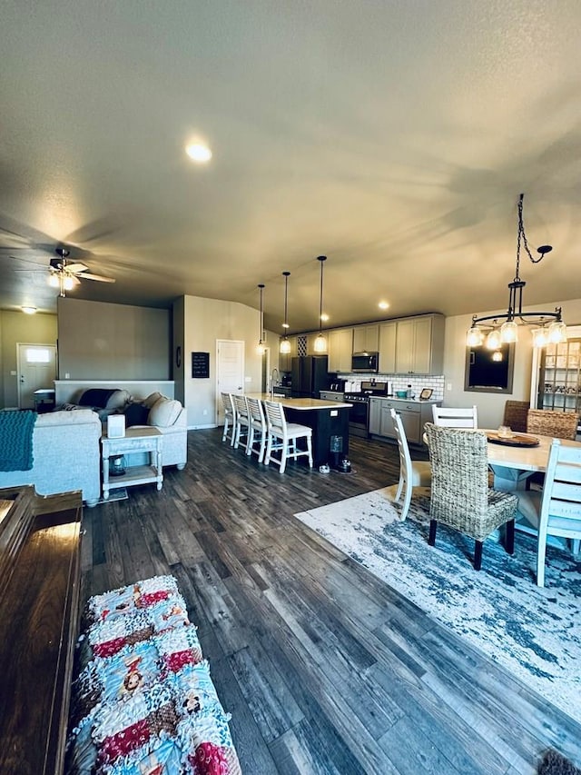 dining room featuring dark wood-style floors, recessed lighting, ceiling fan, and a textured ceiling